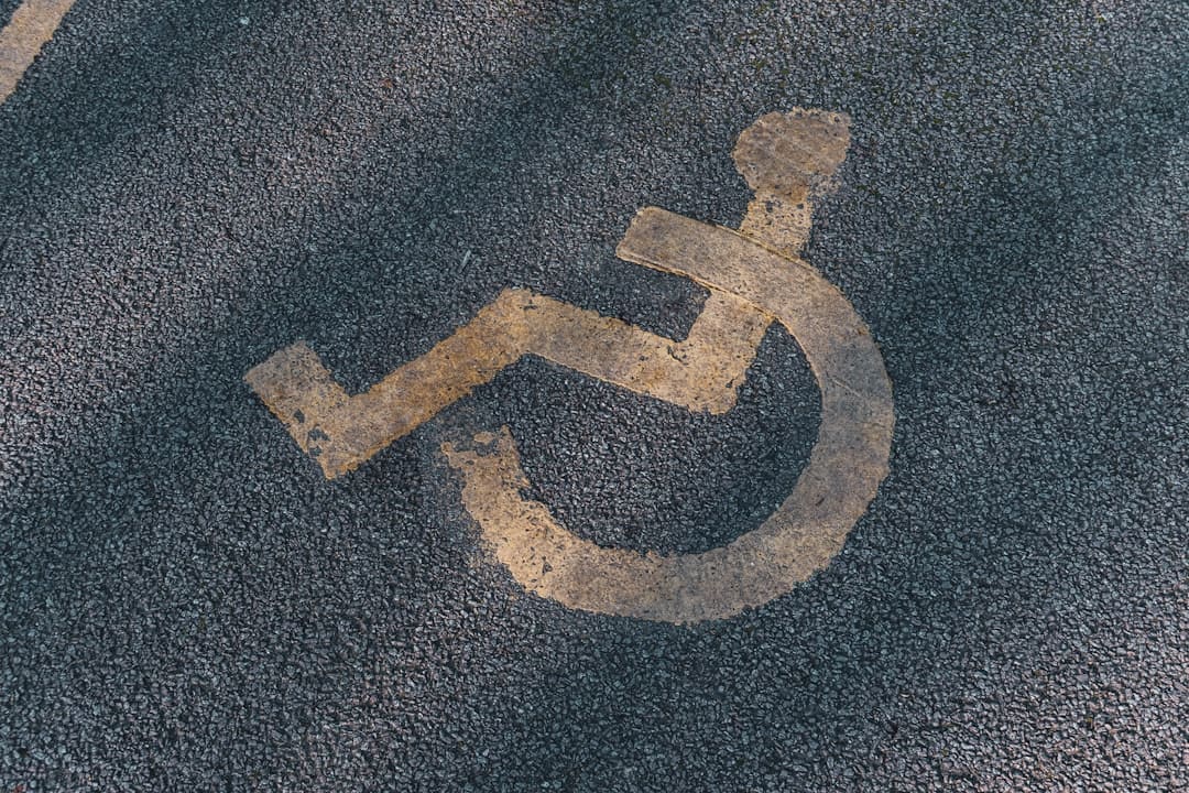 ADA service animal definition — a handicapped sign painted on the asphalt of a parking lot