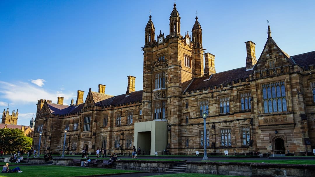 federal housing programs. Historic stone university building with towers and blue sky
