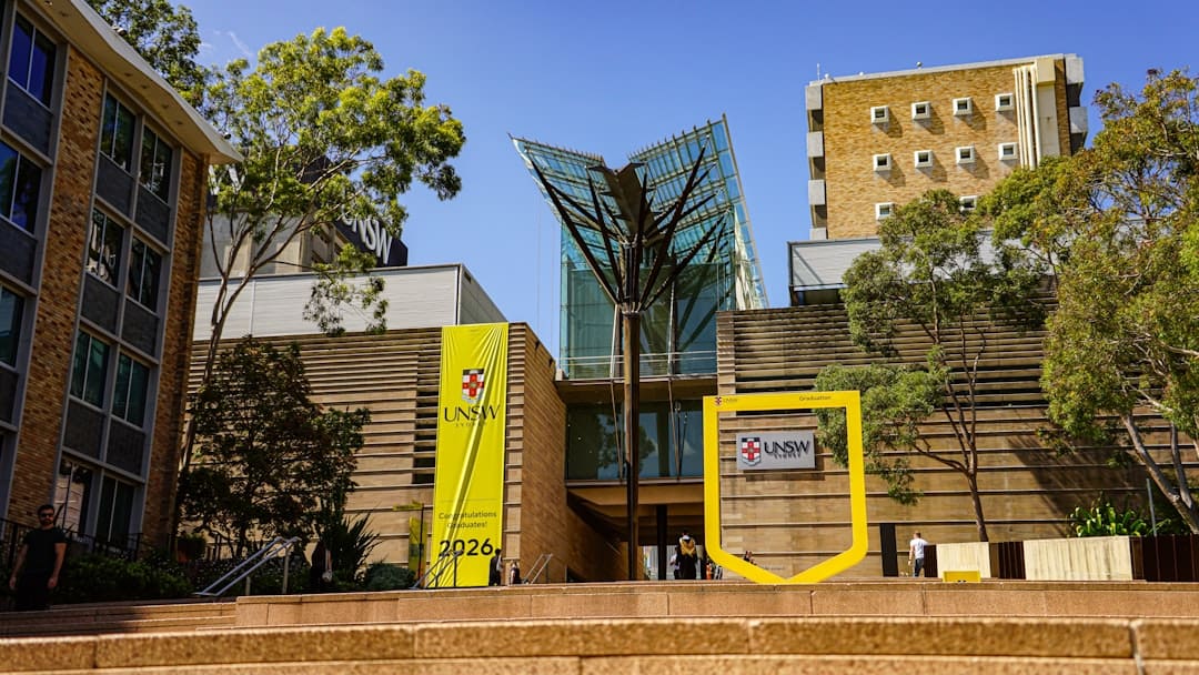 federal housing programs — Modern university building with glass entrance and signage