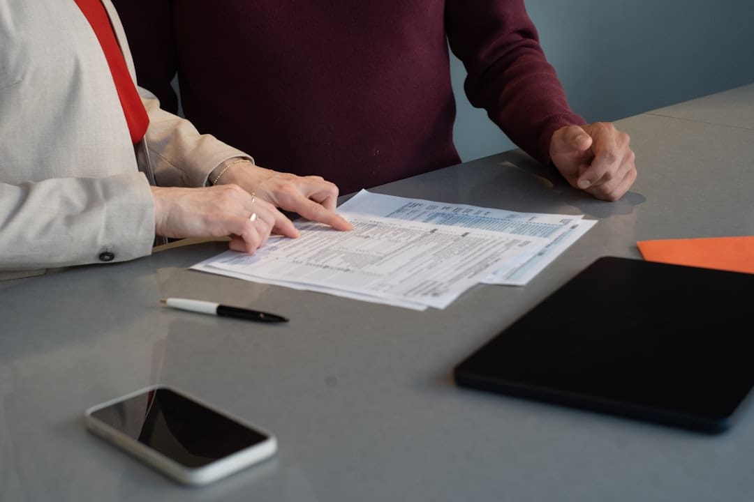 FHA documentation requests — Two people reviewing documents at a table.