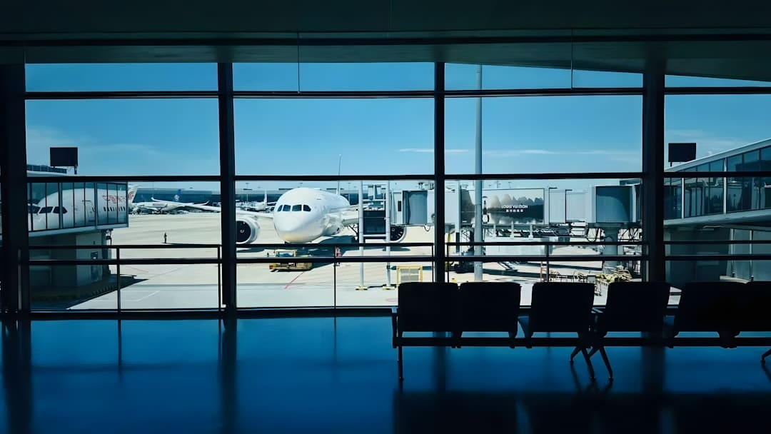 DOT complaint — Airplane at airport gate viewed through window.