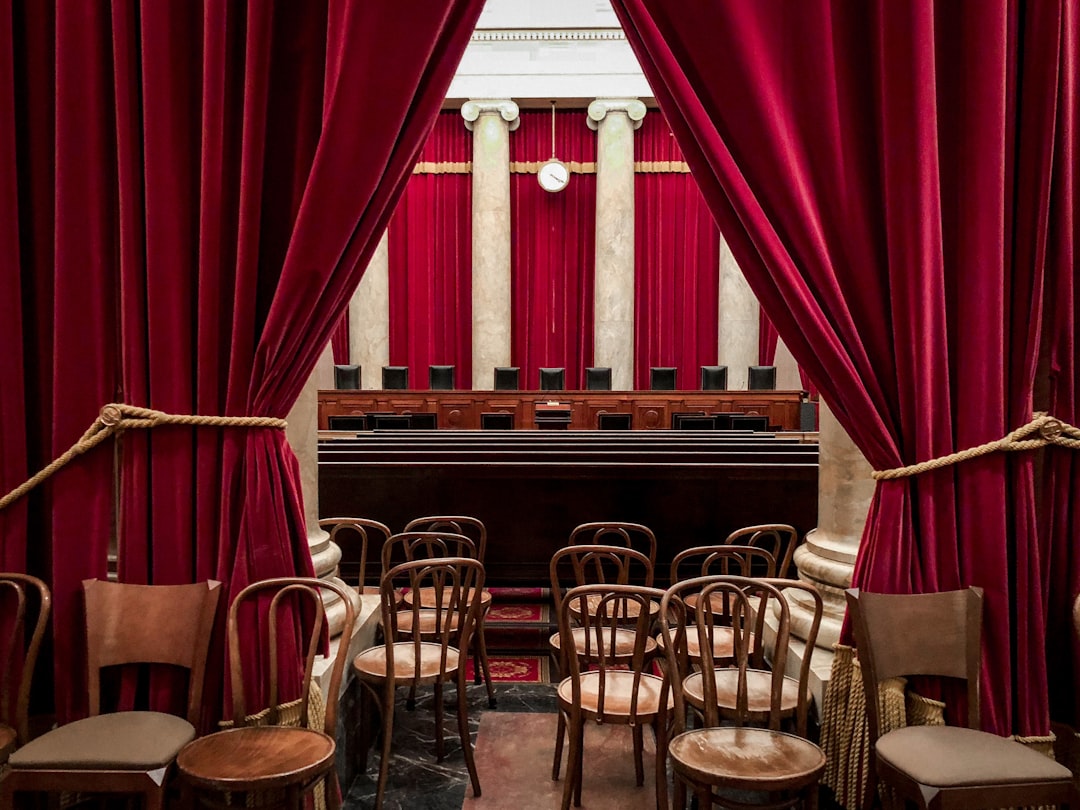 ADA Title II — red curtain near brown wooden chairs