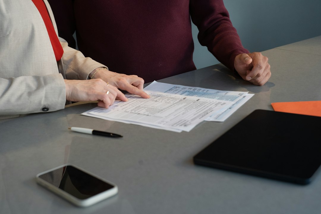 reasonable accommodation request — Two people reviewing documents at a table