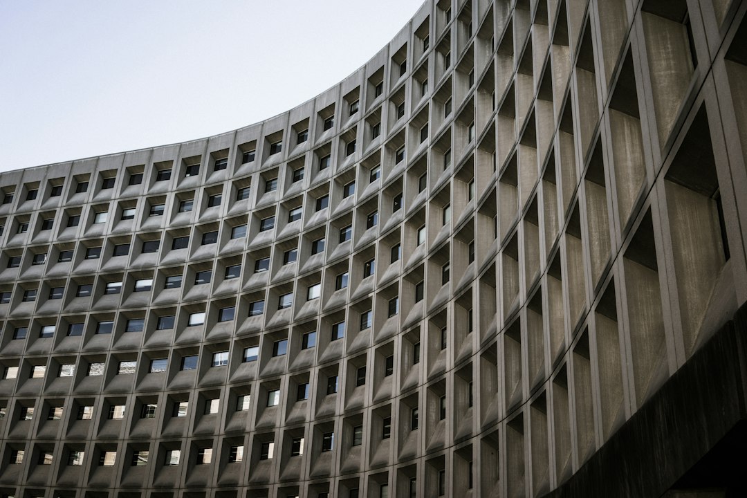 FHA overrides no-pet — a curved building with lots of windows in it